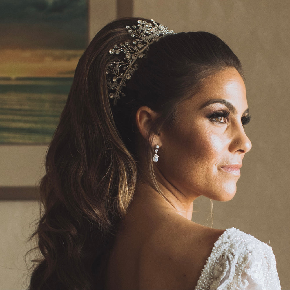 bride wearing half renni clear crystal bridal headpiece by christie lauren