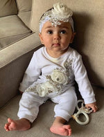 baby wearing white flower sienna couture onesie by christie lauren